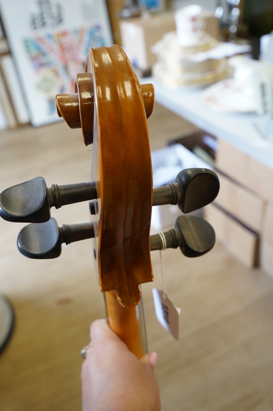 A student’s Golden Strad ‘cello imported by Boosey and Hawkes, body 69.5cm and violin, body 36cm, and a wooden conductors baton. Condition - poor to fair